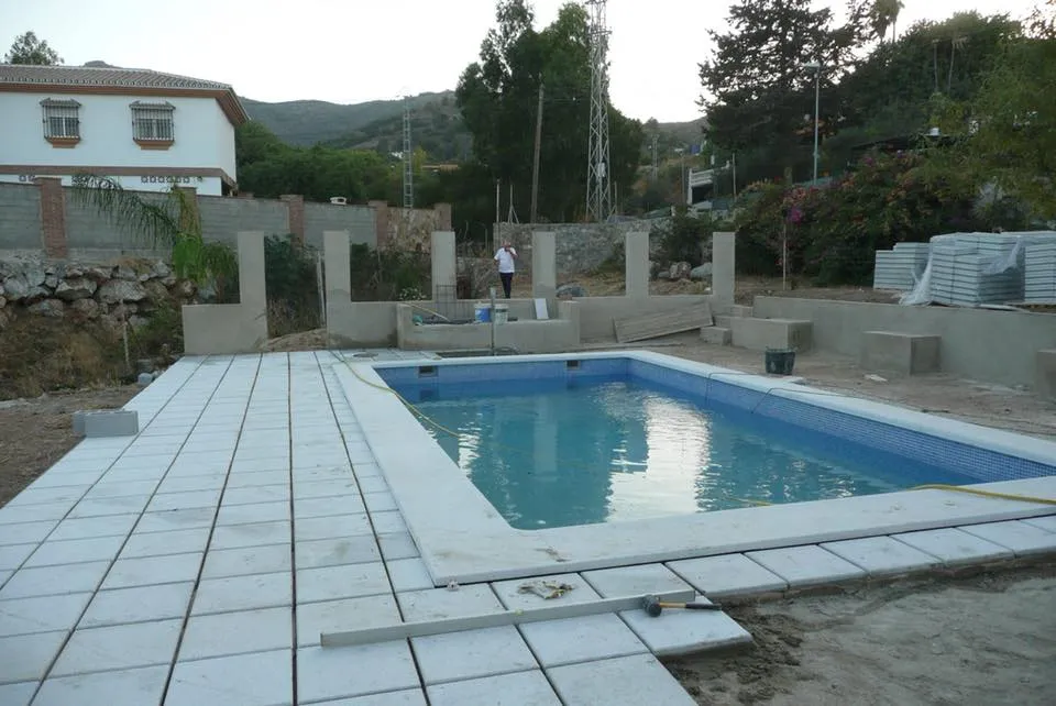 A pool being built in the middle of a yard.